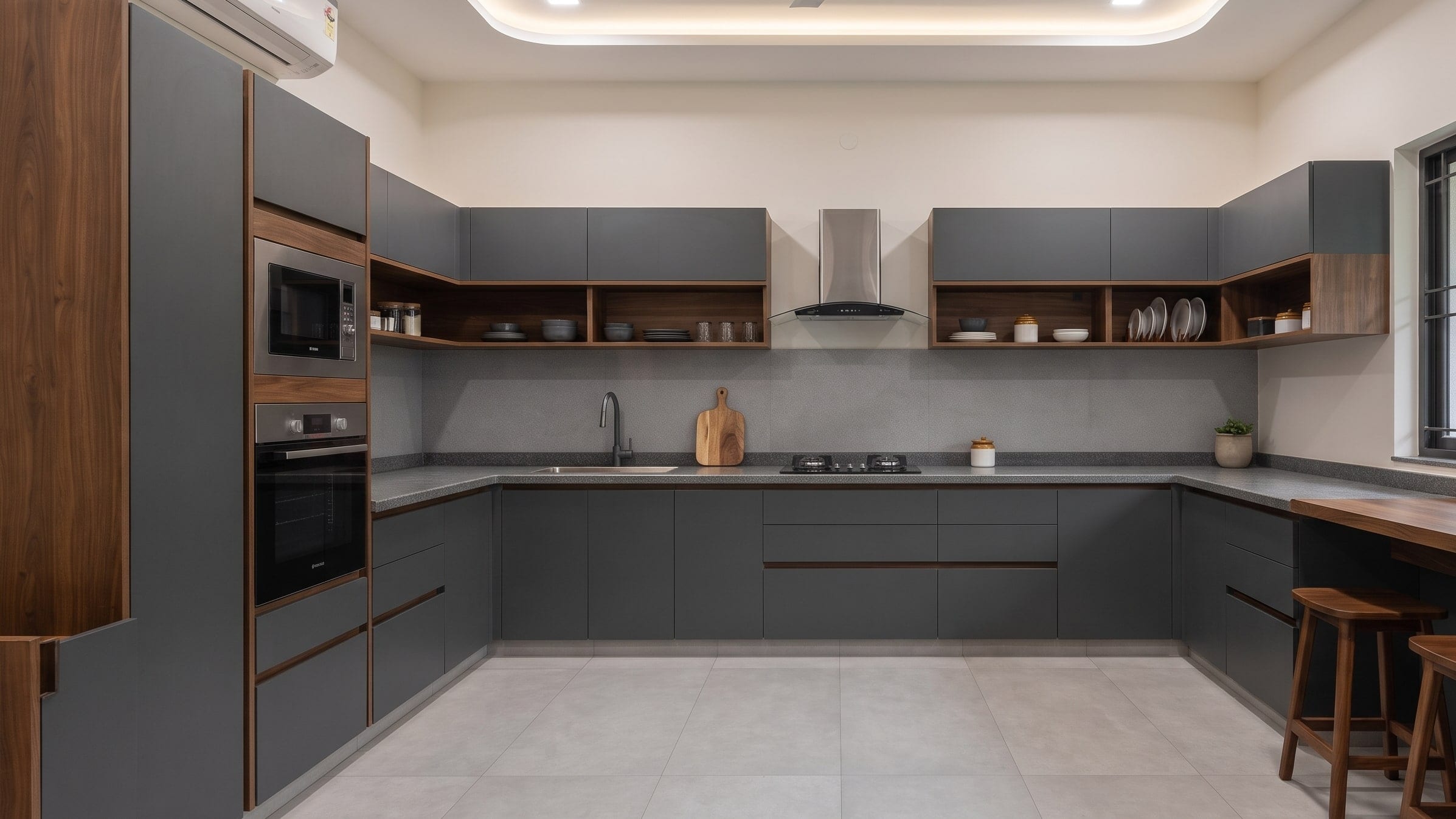 A U-shaped modular kitchen in matte grey and walnut, with a tall oven unit and a breakfast counter